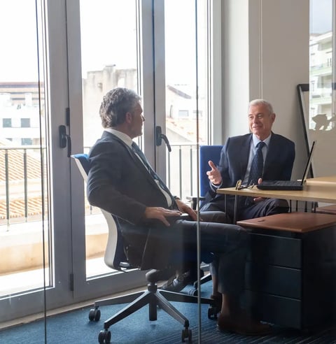 friendly-mature-business-partners-meeting-office